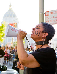 A woman leads the call to protest, photo by Silvia Ros