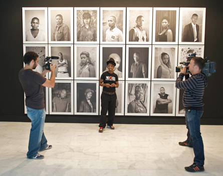 Zanele Muholi in front of her works
